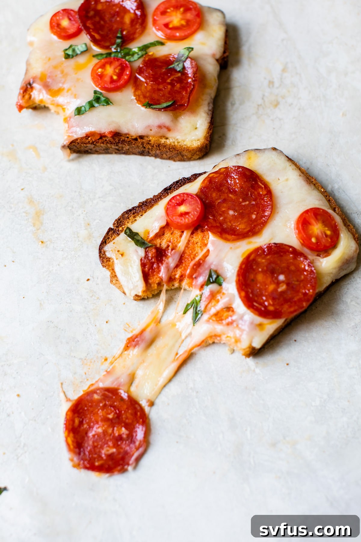 A perfectly cooked slice of pizza toast topped with melted cheese and pepperoni, ready to eat
