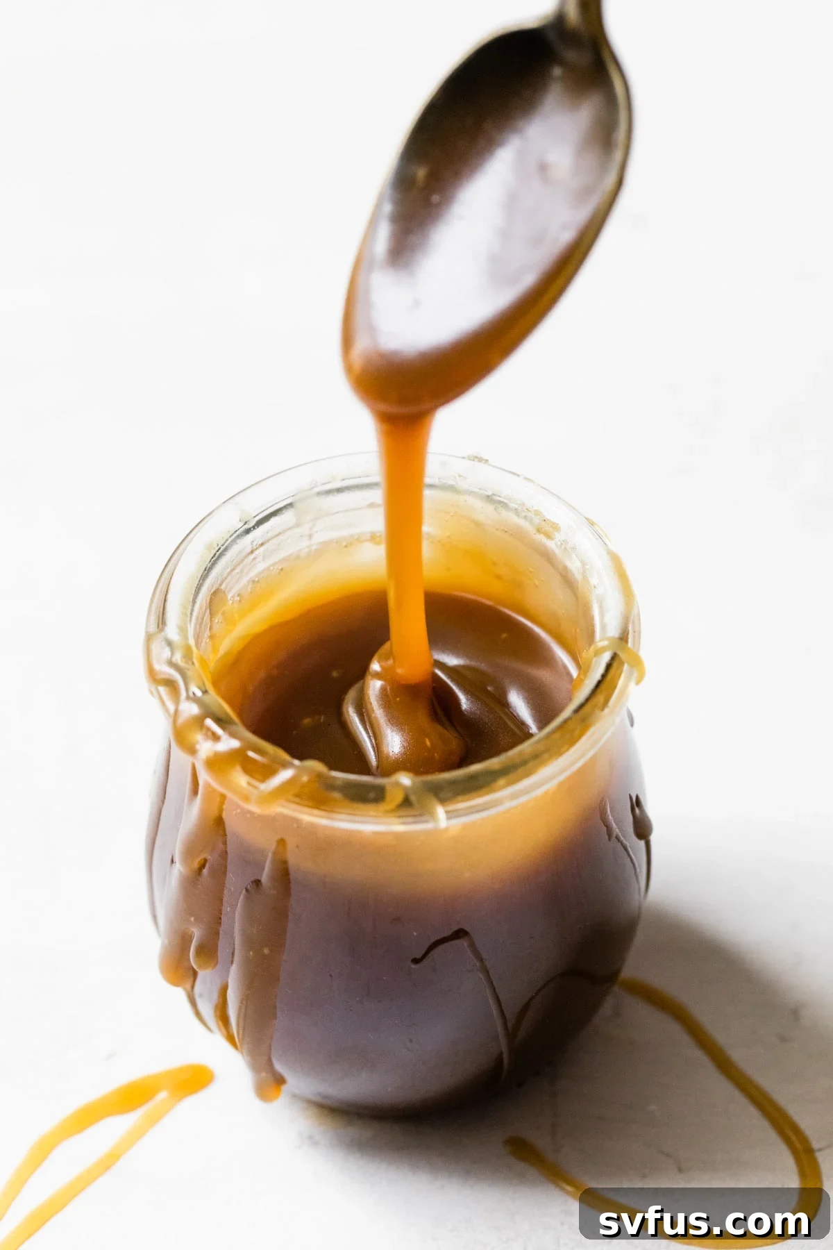A jar filled with luscious healthier salted caramel sauce, ready to be enjoyed.