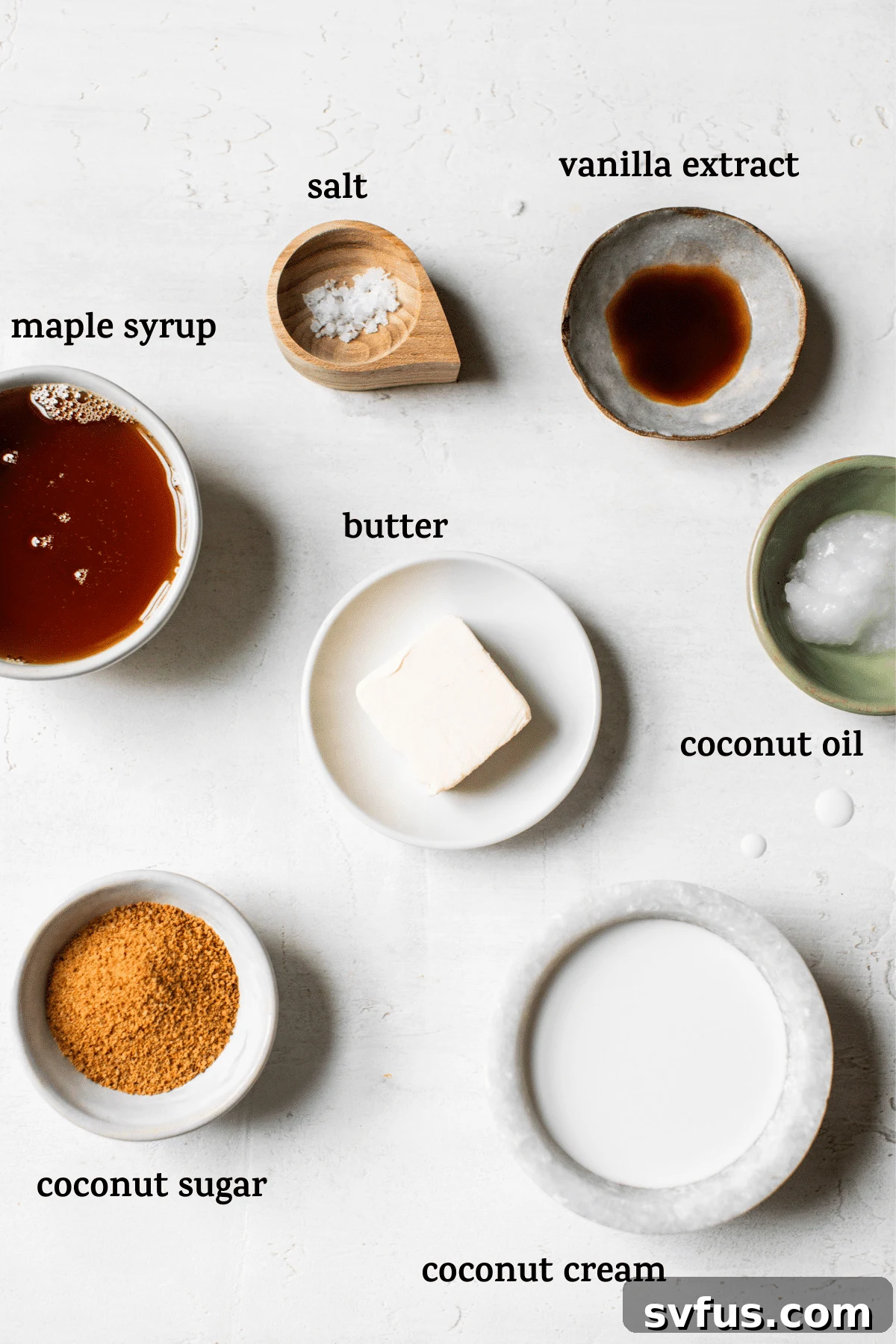 A flat lay photograph showcasing all the fresh, high-quality ingredients needed to make the healthier salted caramel sauce, artfully arranged on a light surface with descriptive text overlays.
