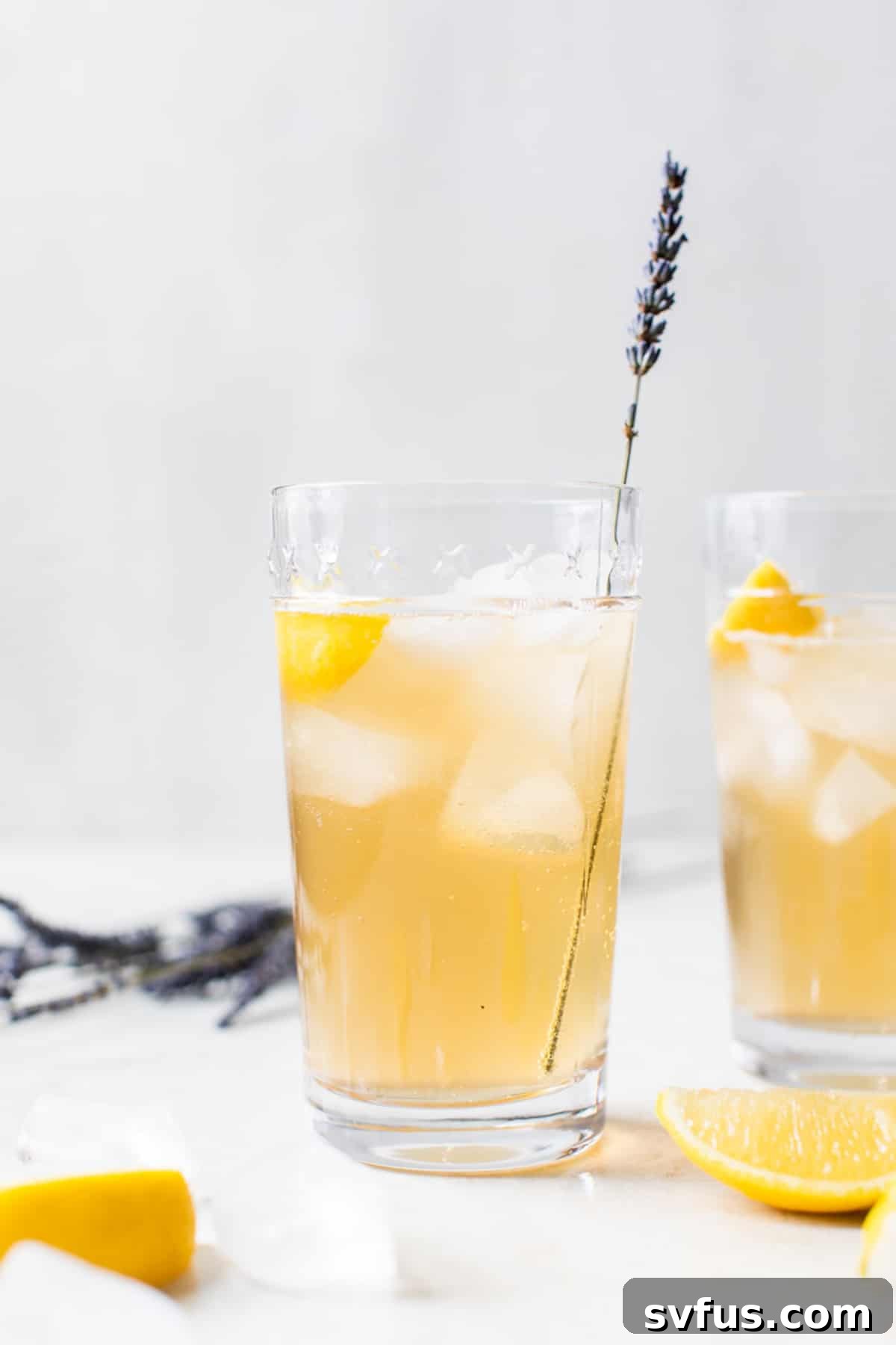 cocktail in a glass with a sprig of lavender