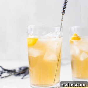 cocktail in a glass with a sprig of lavender