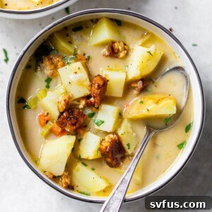 bowl of potato soup with a spoon
