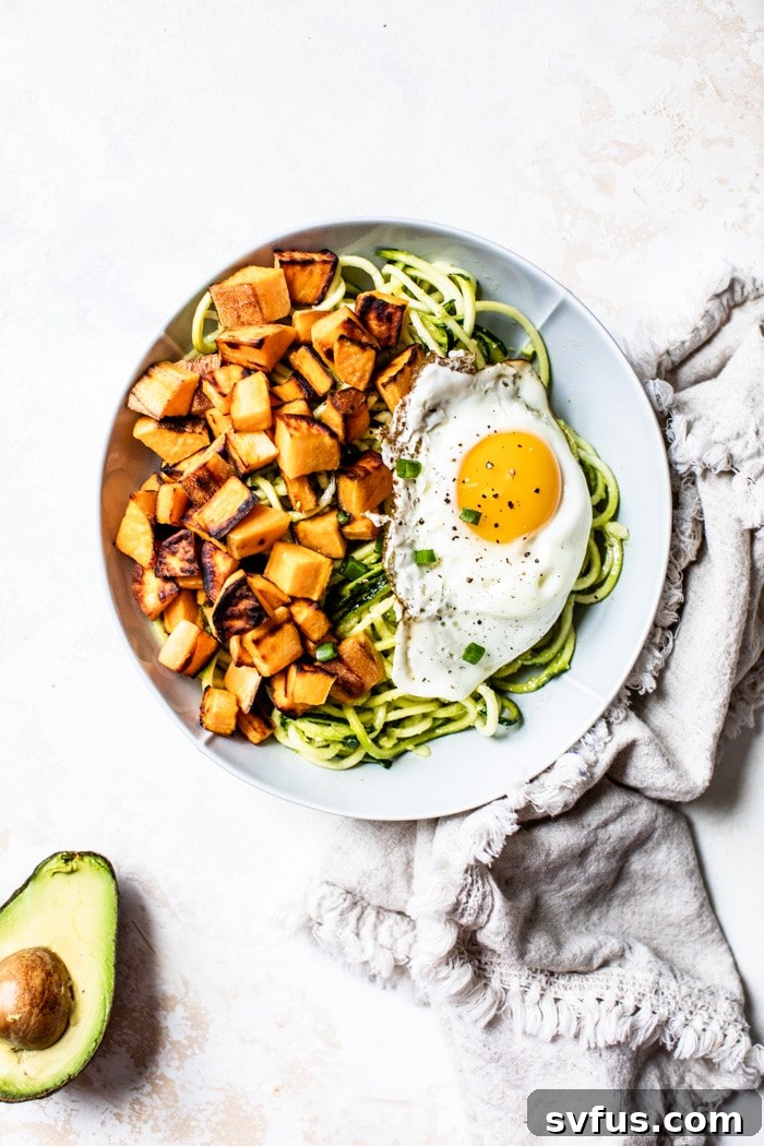 A beautifully presented Whole30 zucchini noodle breakfast bowl, rich in healthy fats, protein, and complex carbohydrates.