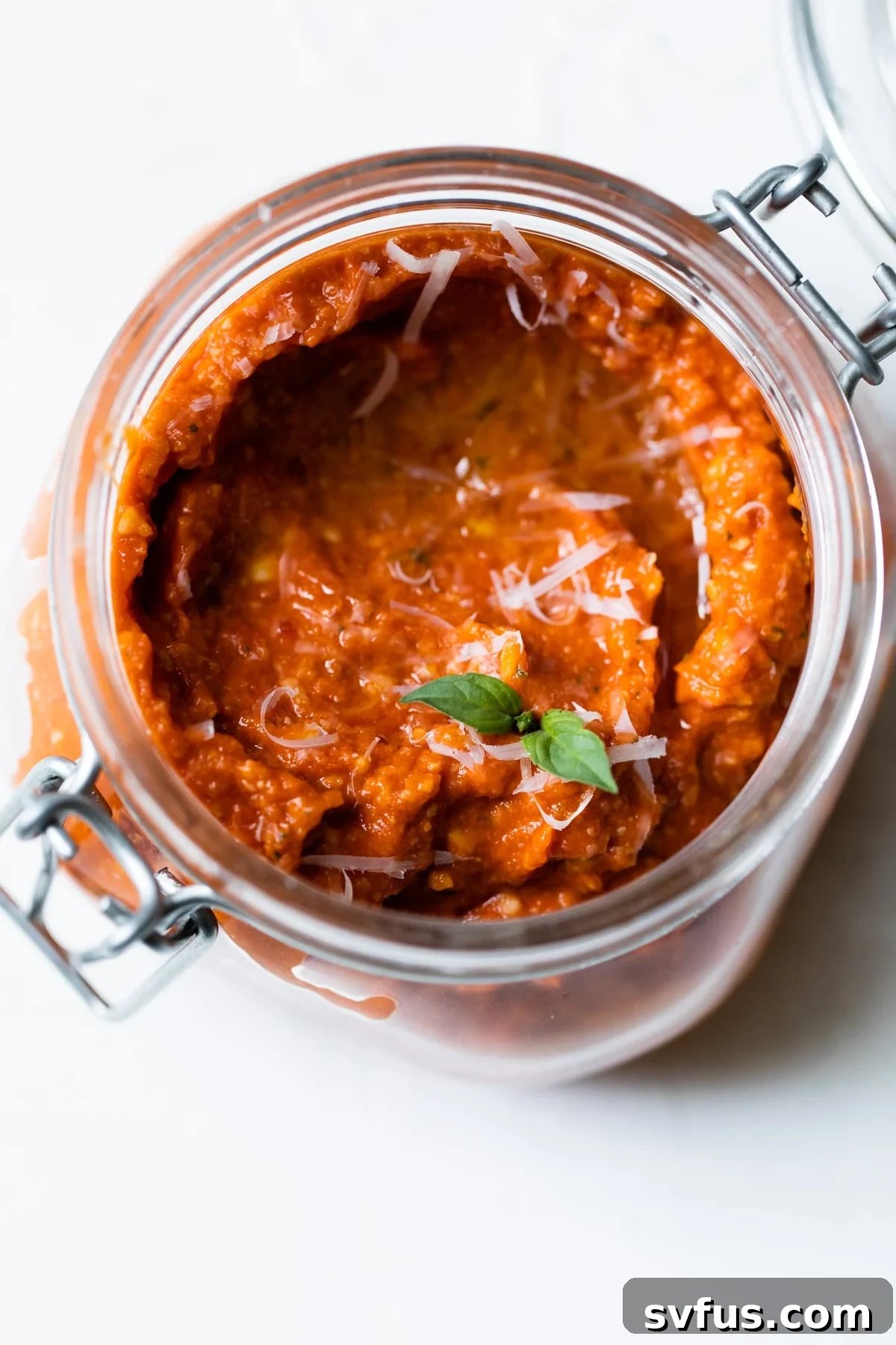 jar of sun dried tomato pesto topped with parmesan cheese