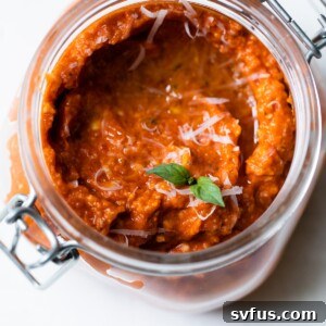 jar of sun dried tomato pesto topped with parmesan cheese