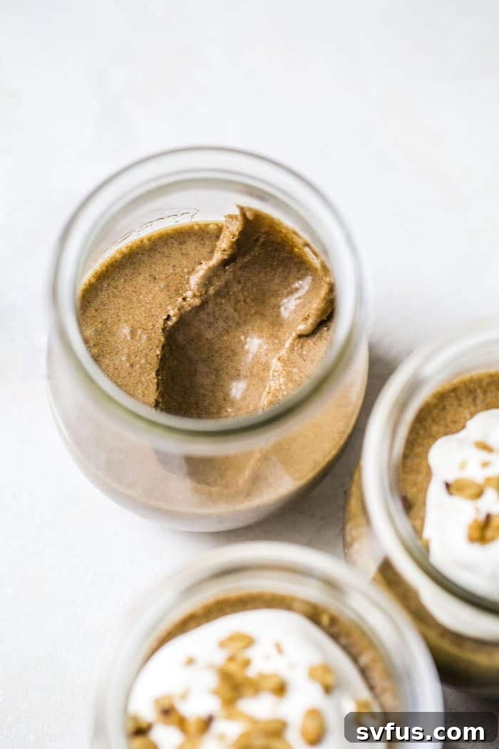 Close-up of creamy dairy-free mousse with a smooth texture in a glass jar.