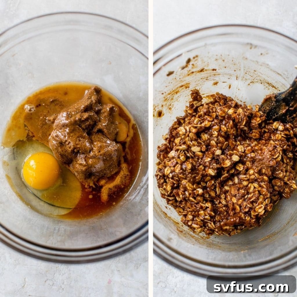 A large clear glass bowl showcasing the wet ingredients (egg, almond butter, maple syrup, vanilla) and the dry cookie ingredients (oats, sugar, baking soda, cinnamon, salt) waiting to be combined.