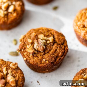 Paleo pumpkin muffins topped with walnuts