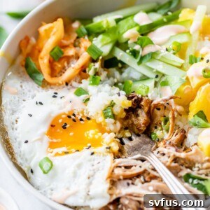 an over easy egg with runny yolk over pulled pork