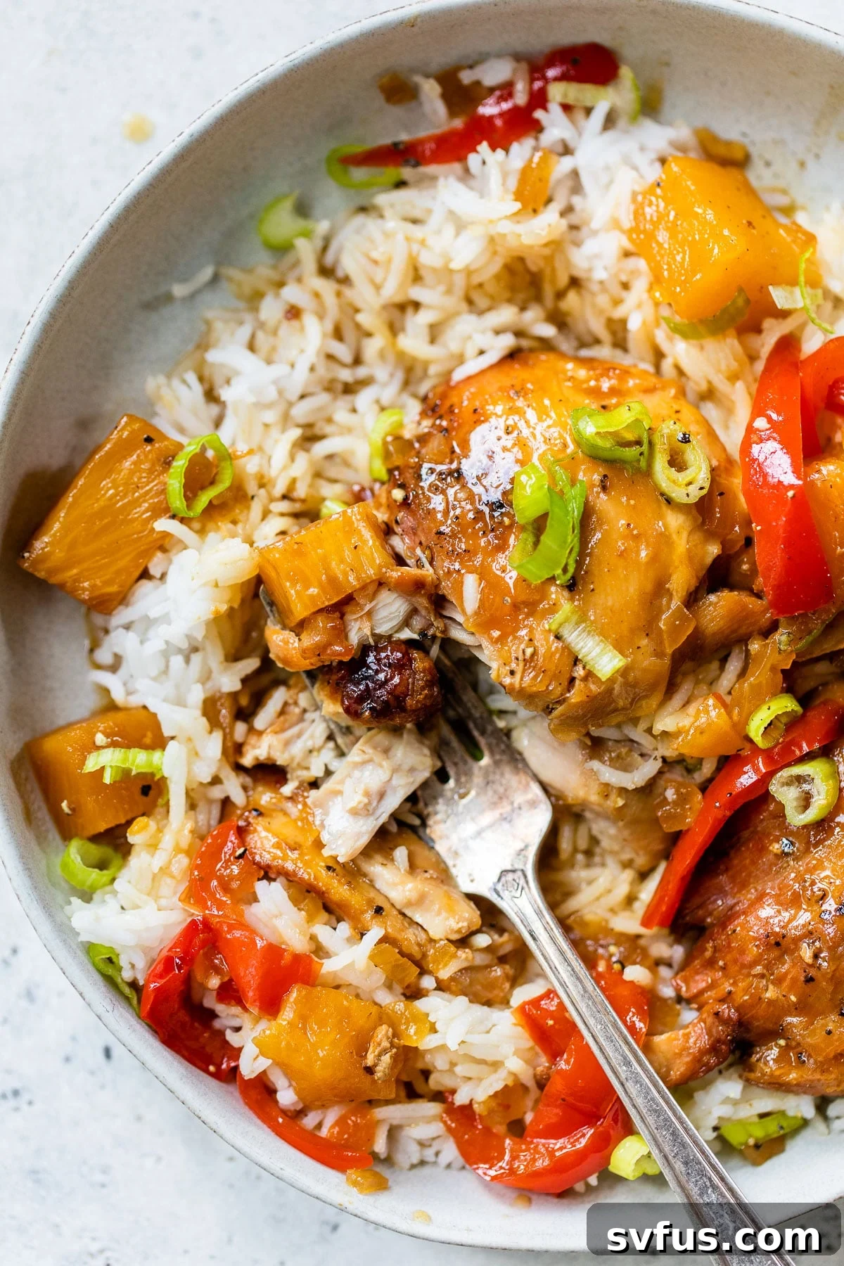 A delicious bowl of Crockpot Hawaiian Chicken served with white rice, ready to be enjoyed.