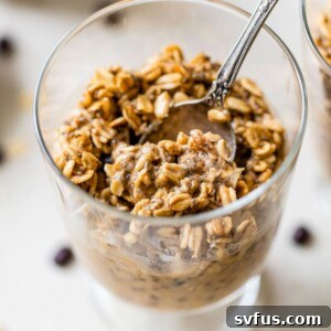 Coffee overnight oats in a glass jar with a spoon in it