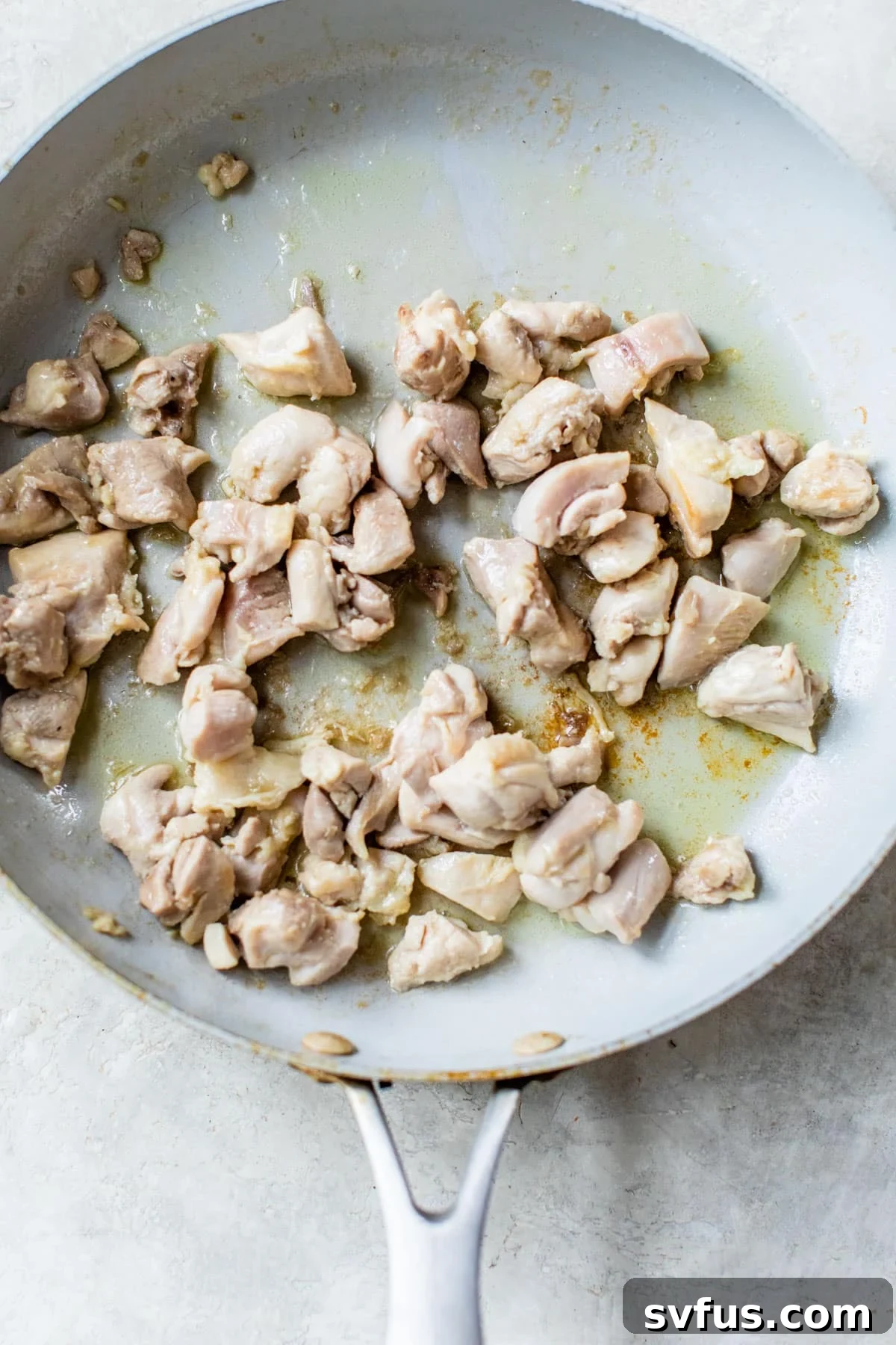 diced cooked chicken in a skillet