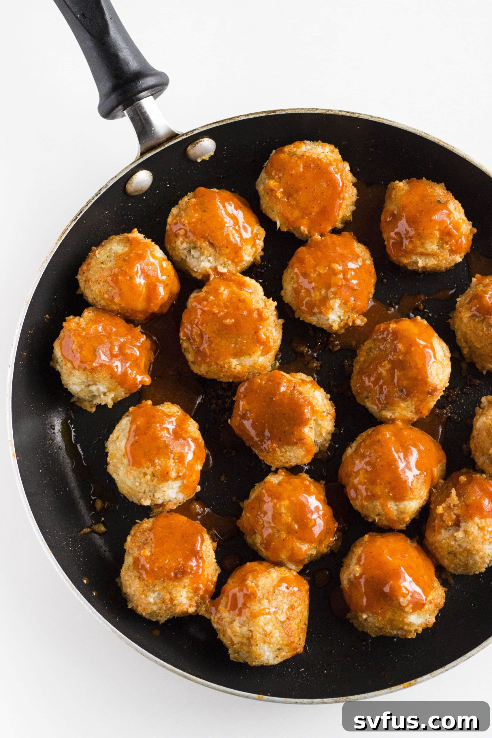 Platter of Buffalo Cauliflower Quinoa Meatballs, garnished and ready to serve.