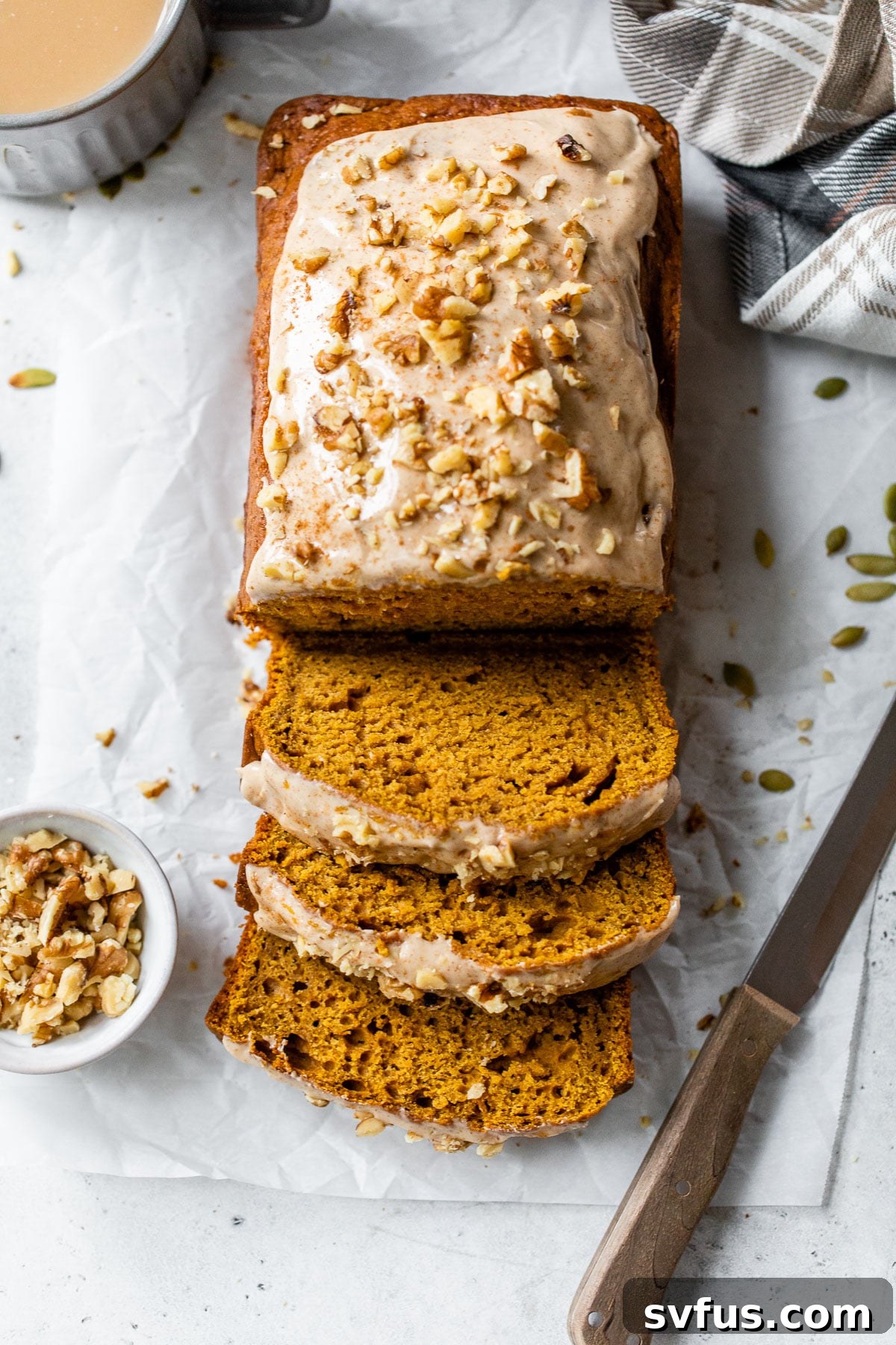 sliced loaf of bread topped with chopped walnuts