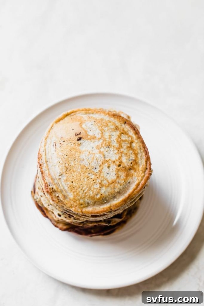 Close-up of golden-brown pancakes speckled with chia seeds, ready to be served