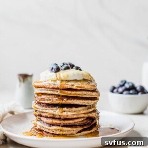 Fluffy chia seed pancakes topped with lemon zest and blueberries