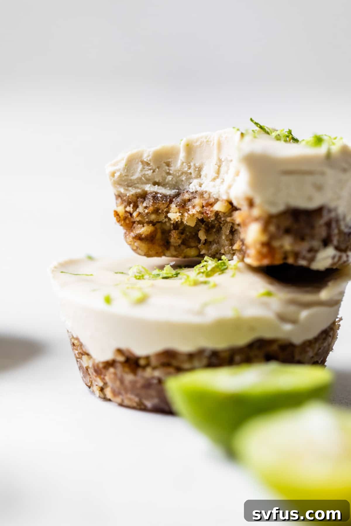 A stack of beautifully crafted vegan key lime pie tarts, showcasing their vibrant color and inviting texture, ready for a close-up shot.