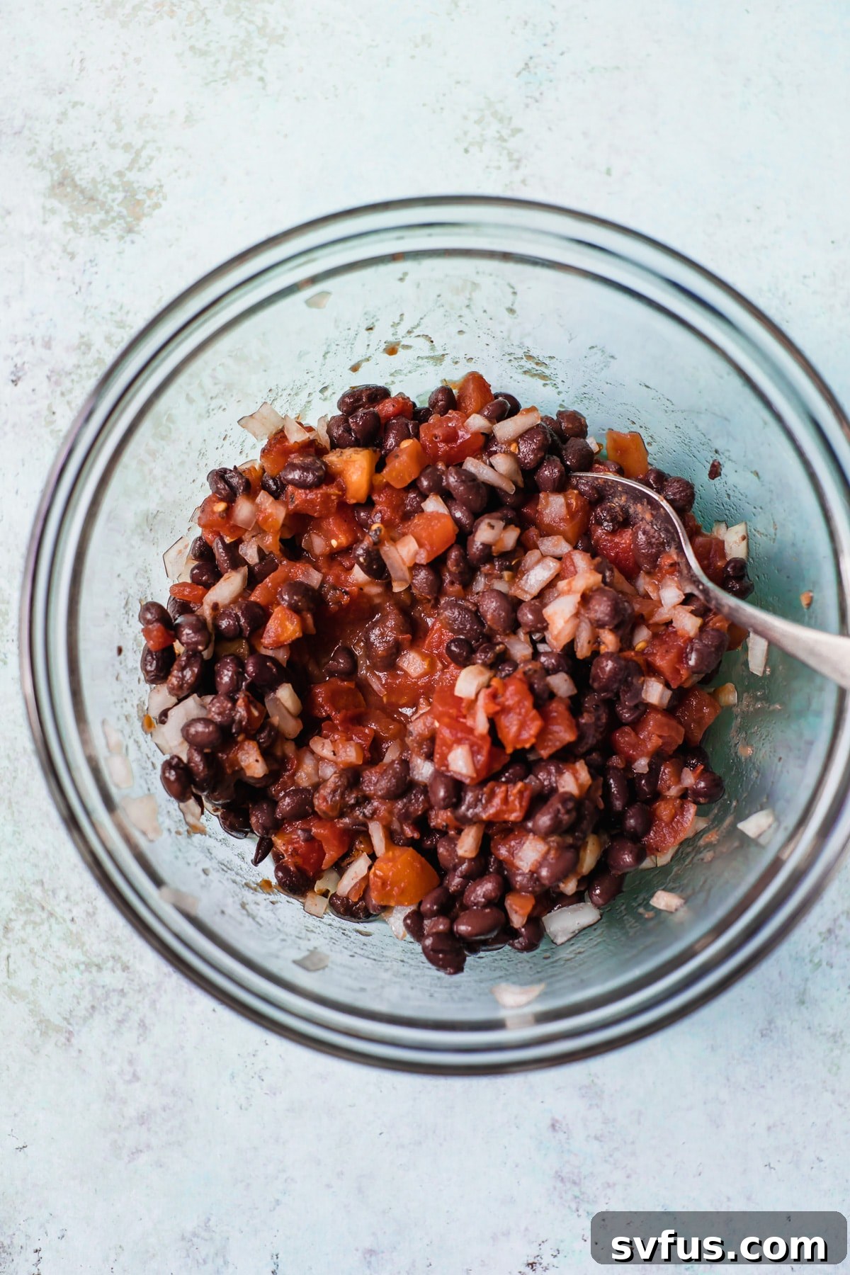 bowl of tomatoes, black beans and onion