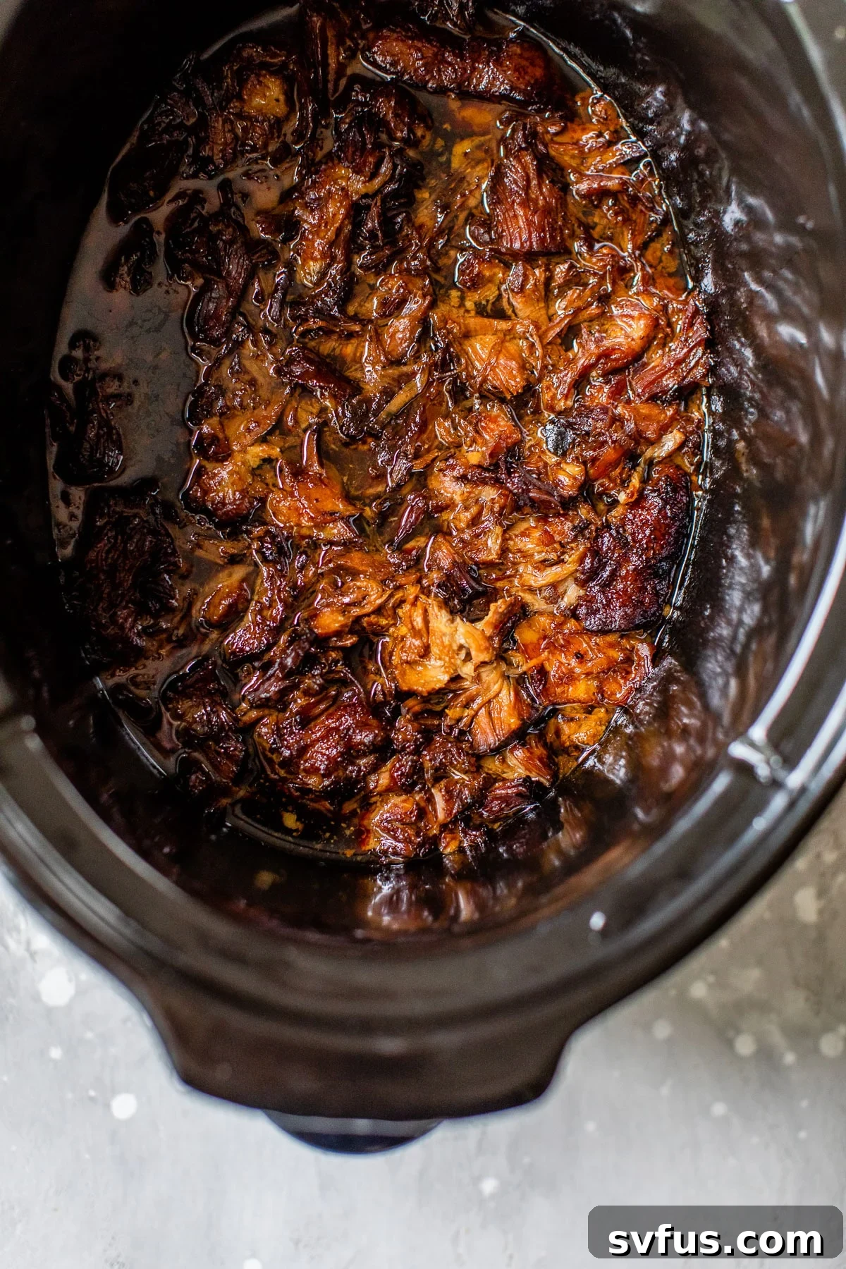 cooked shredded pork in the slow cooker