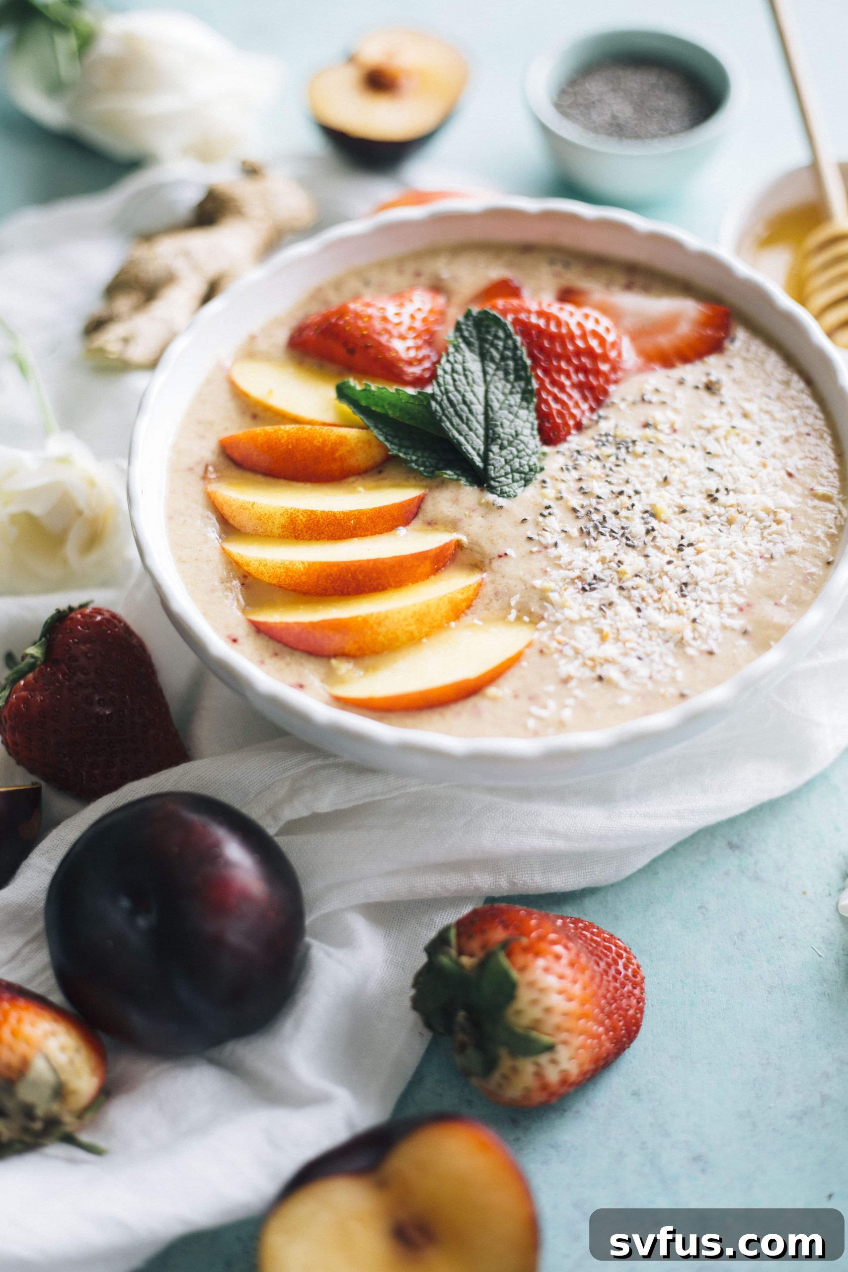 Vibrant Nectarine Ginger Smoothie Bowl topped with fresh fruit, a perfect healthy vegan breakfast