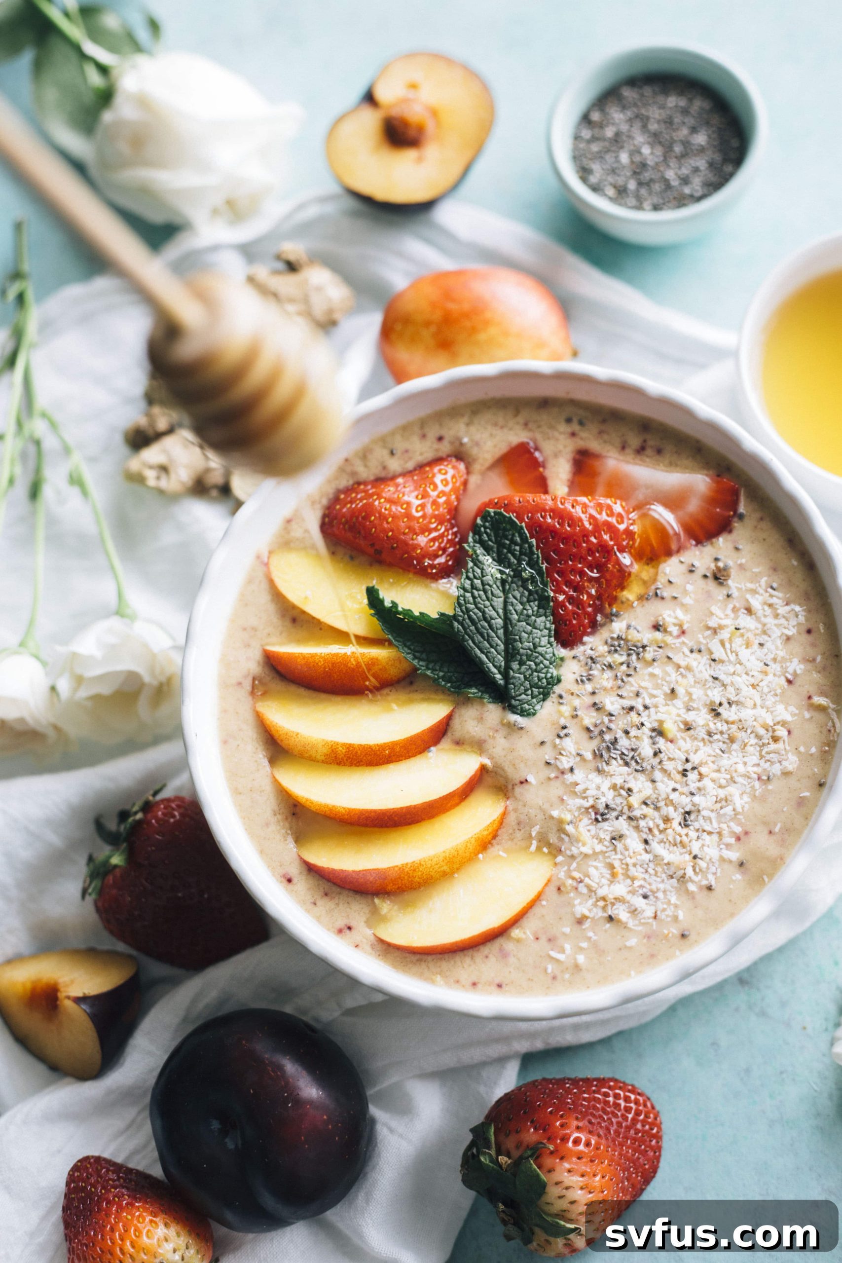 Close-up of a Nectarine Ginger Smoothie Bowl with various toppings, highlighting the healthy ingredients