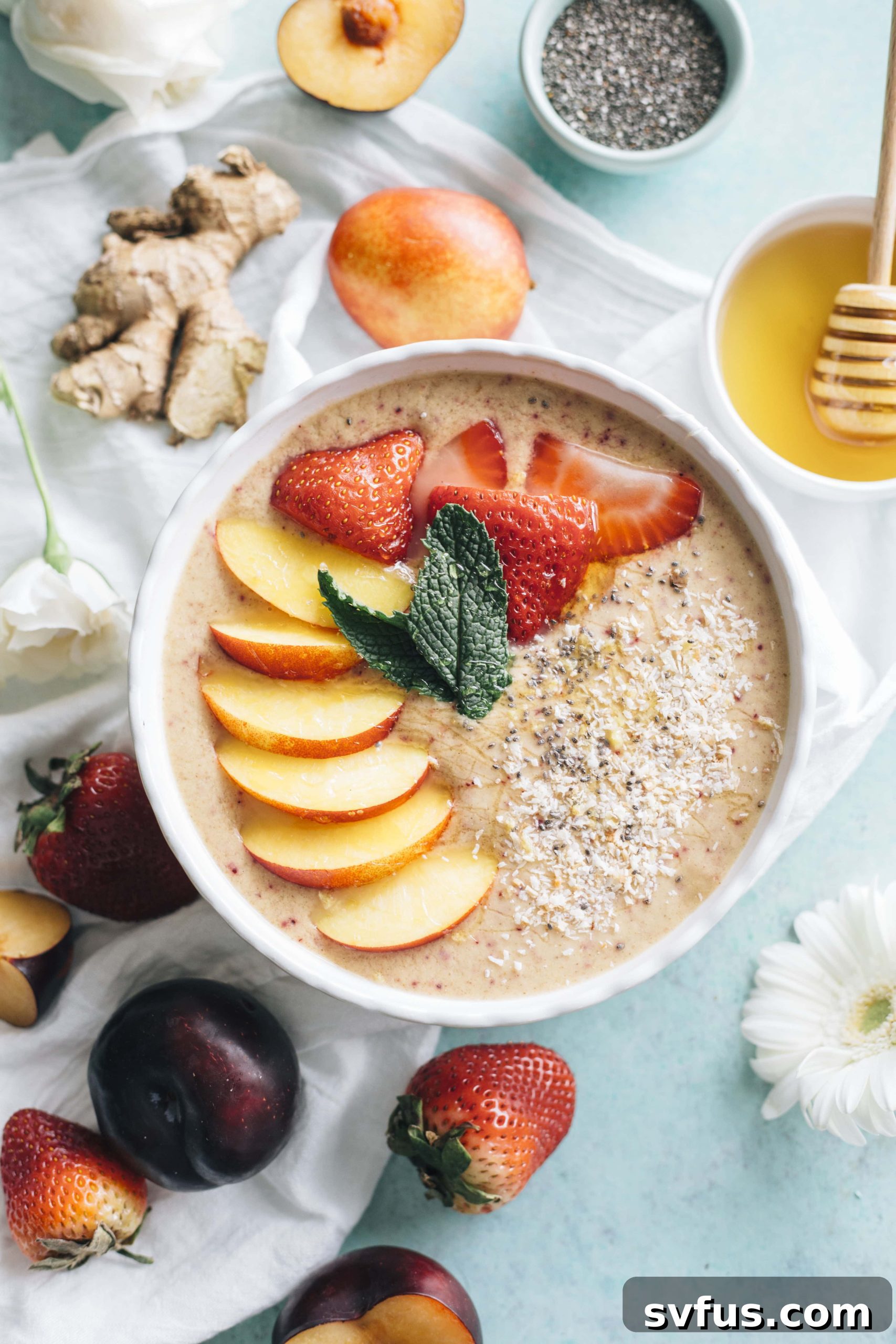 Nectarine Ginger Smoothie Bowl garnished with chia seeds and mint, emphasizing its vegan and healthy nature