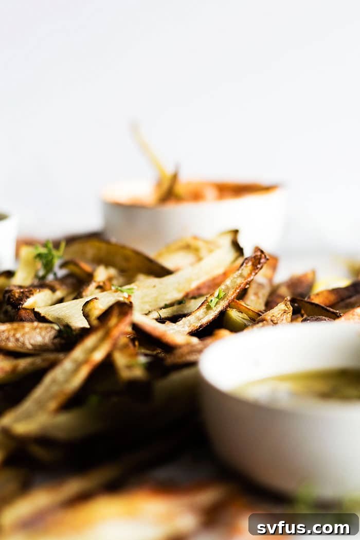 Homemade baked french fries displayed beautifully, ready for guests to add their choice of gourmet condiments at a fun party.