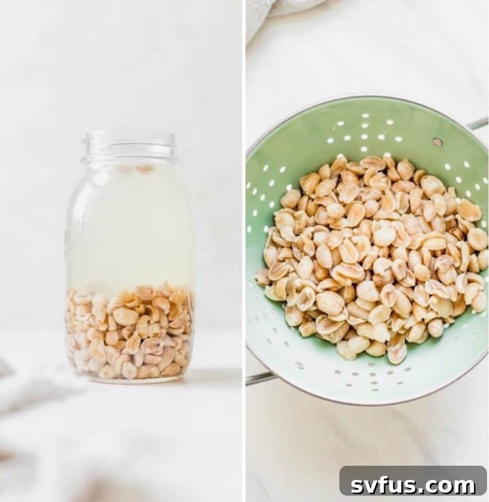 Soaked peanuts in a glass jar next to a green strainer, ready for rinsing.