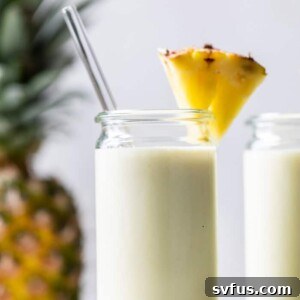 smoothie in a glass with a pineapple wedge