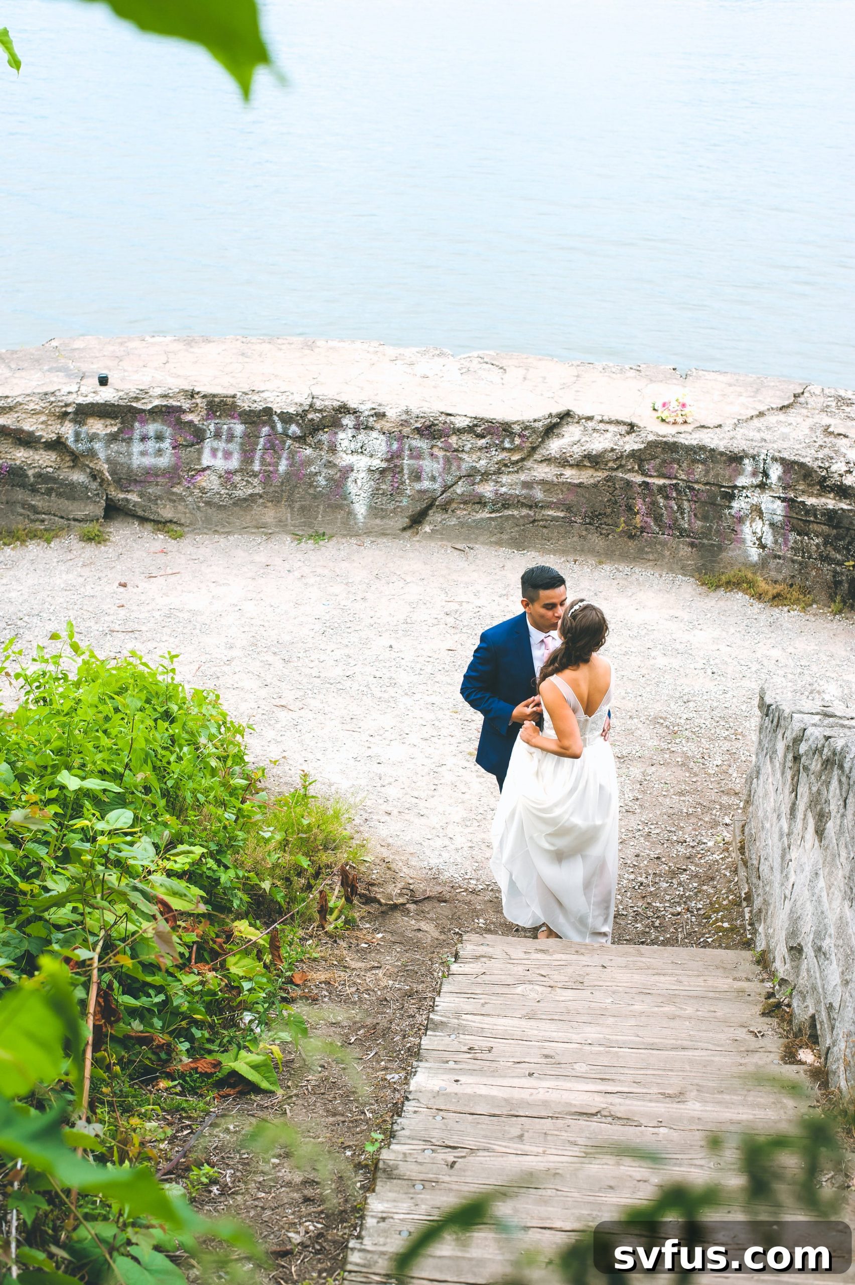 Groom looking lovingly at his bride during their wedding photoshoot