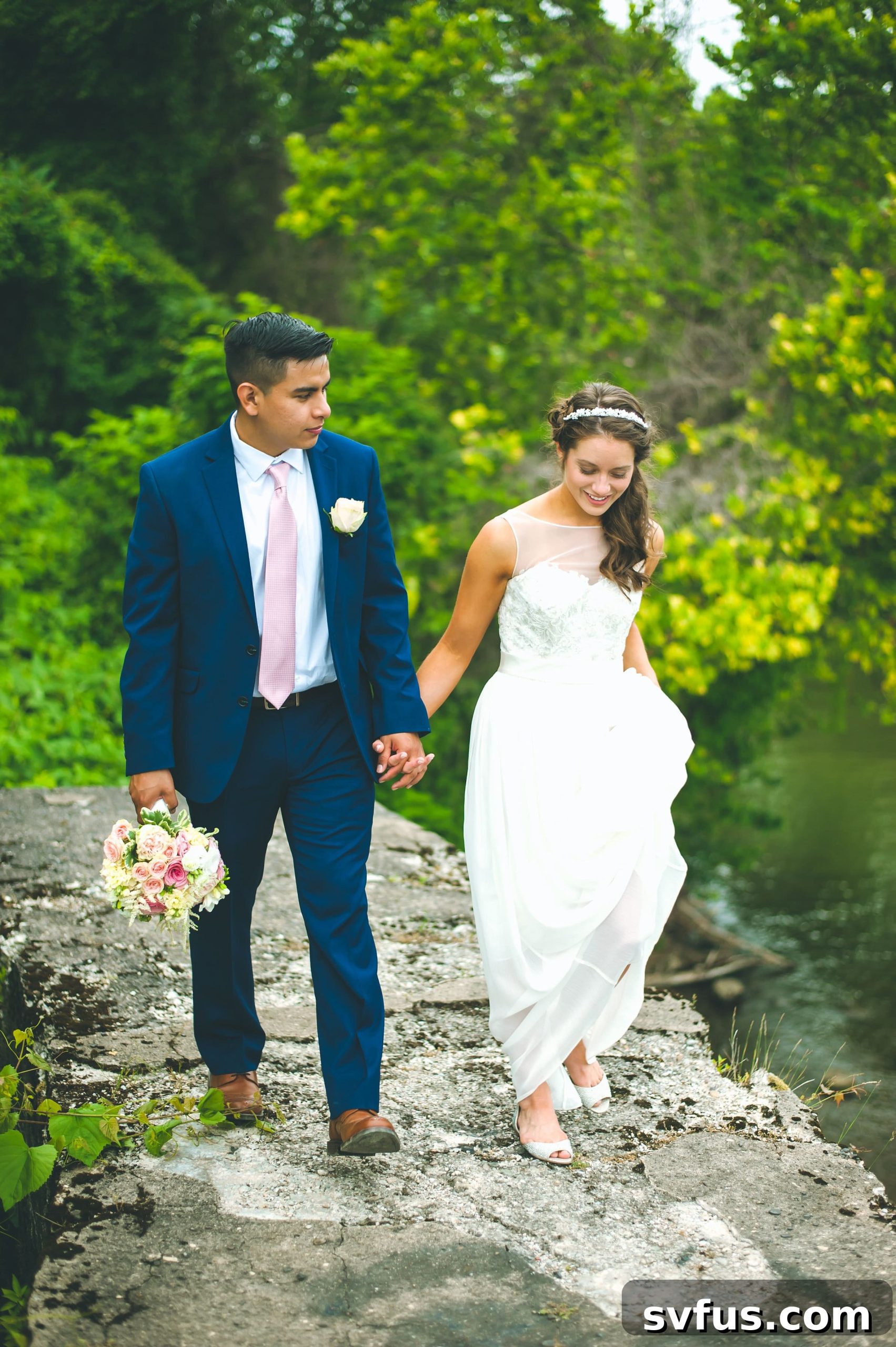 The newly married couple sharing a joyful moment during their portraits