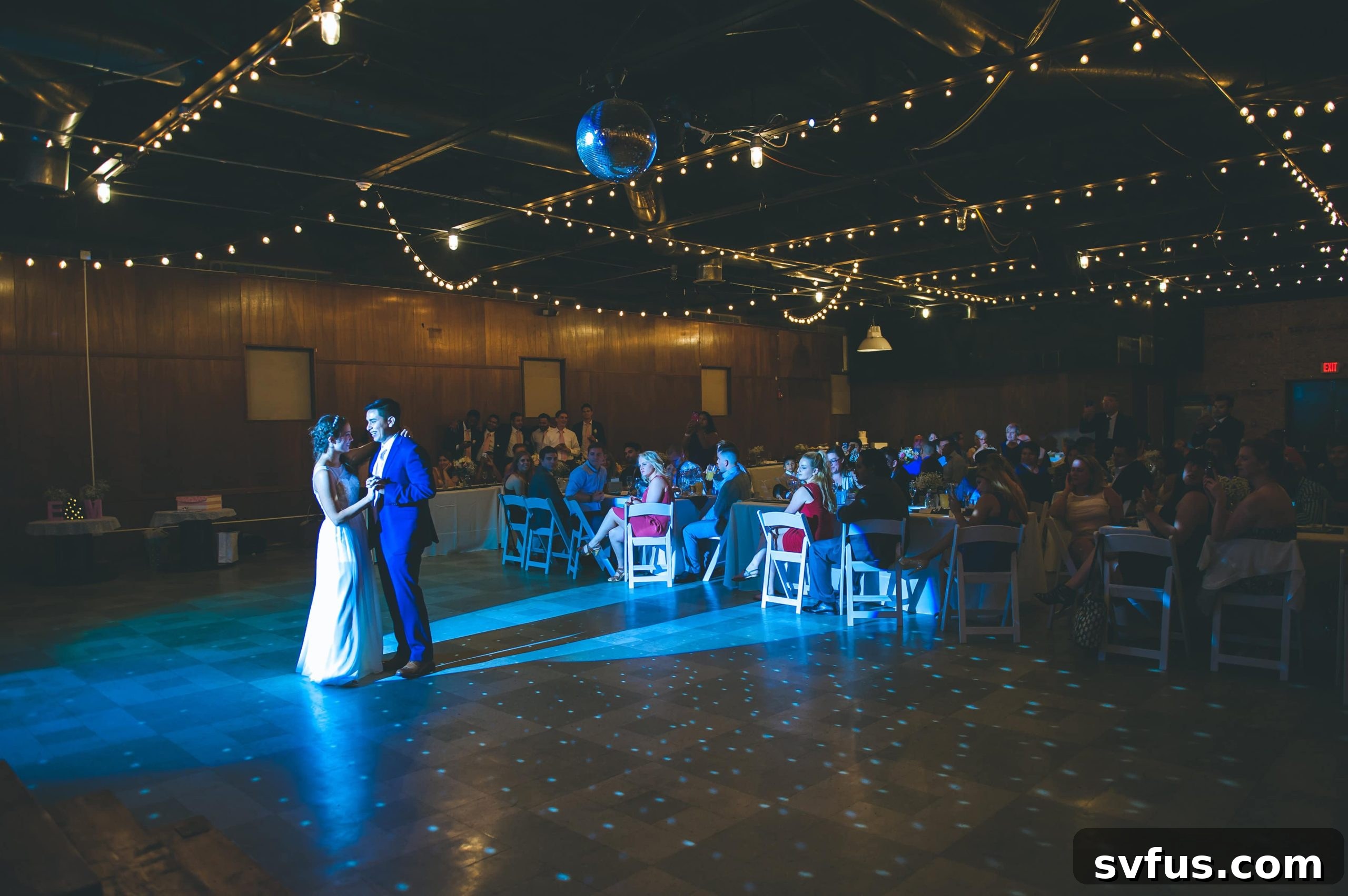 Bride and groom enjoying their first dance at the wedding reception