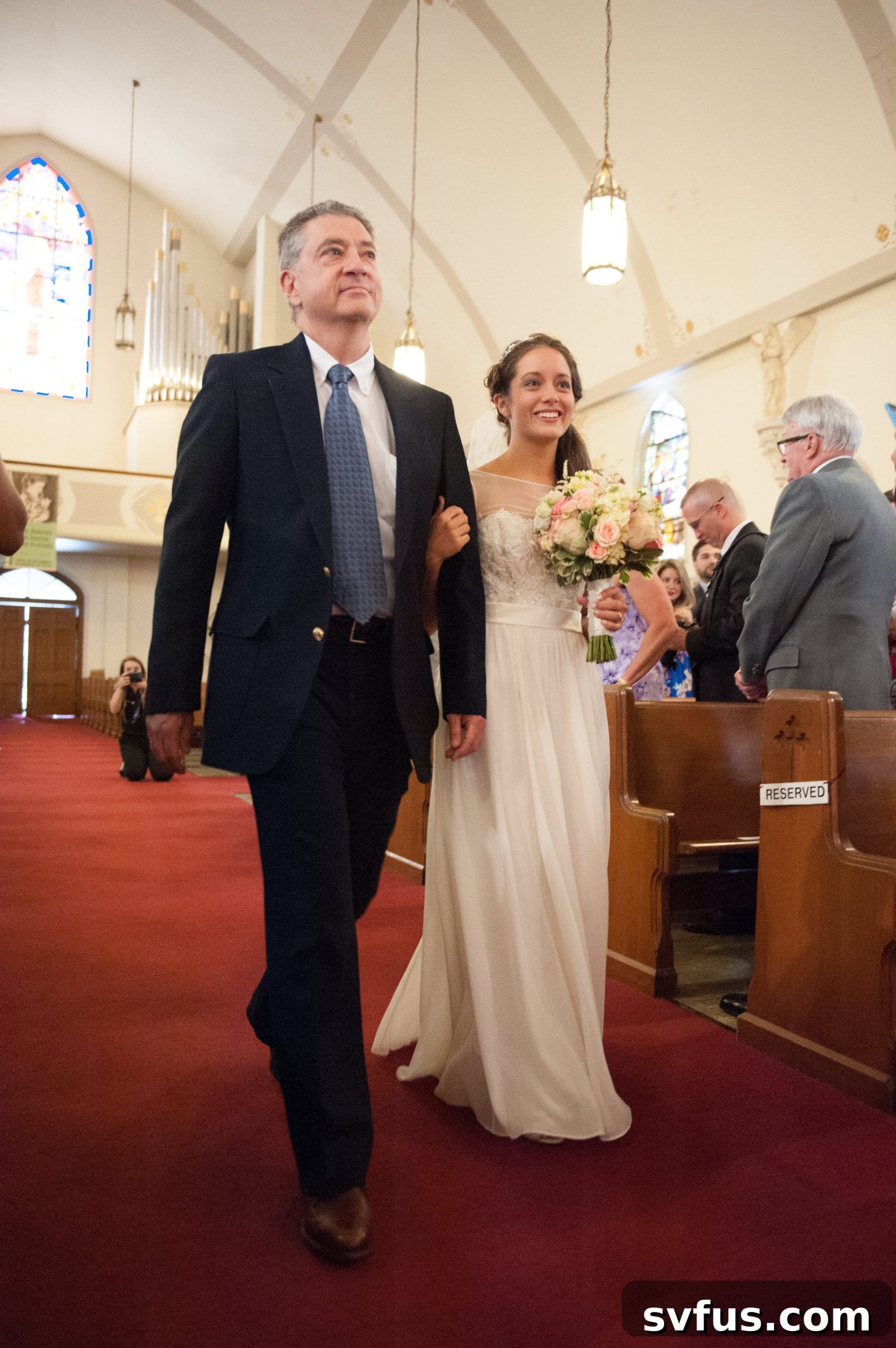 Bride walking down the aisle at Saint Maria Goretti Church