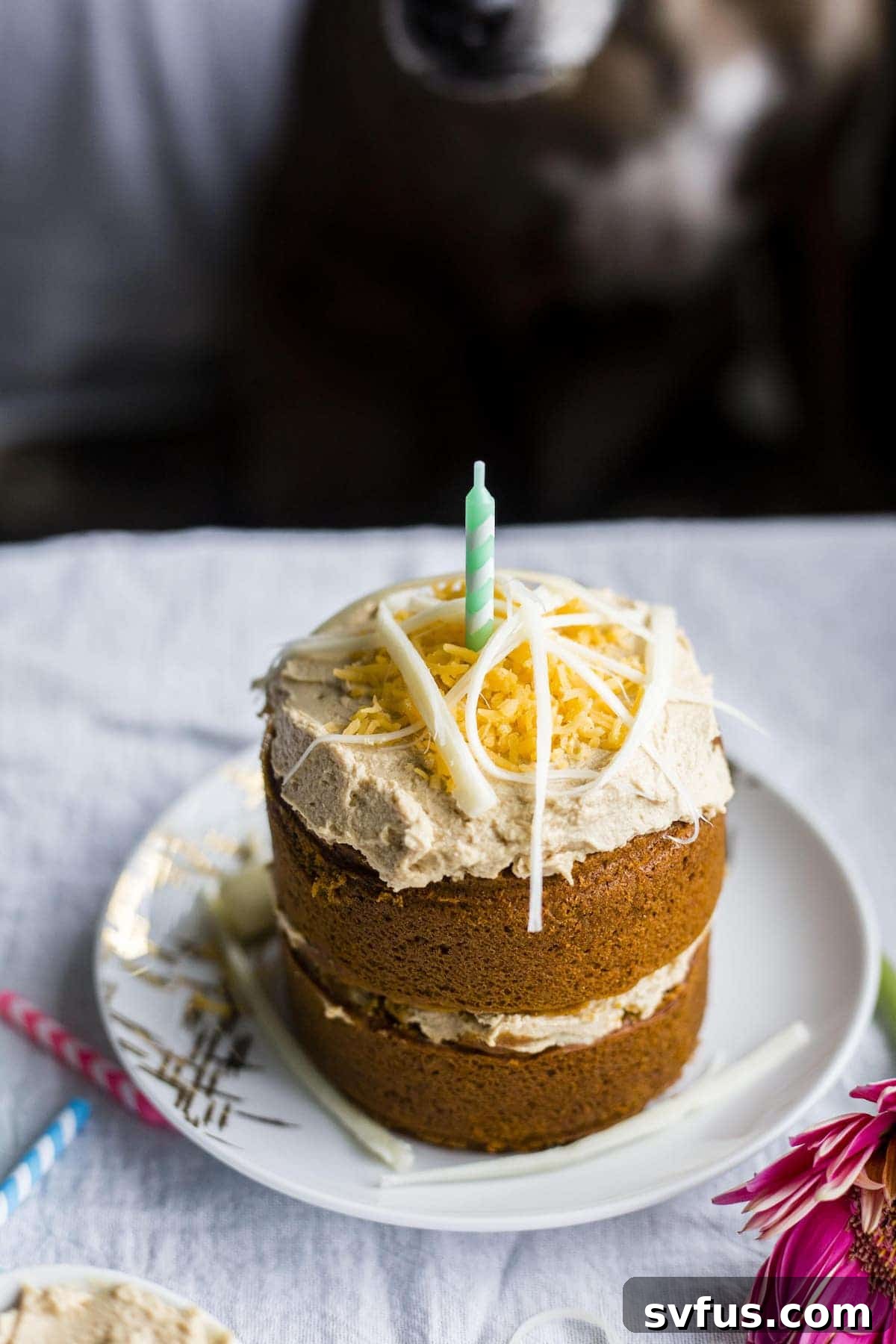 A delicious homemade mini dog birthday cake topped with shredded cheese.