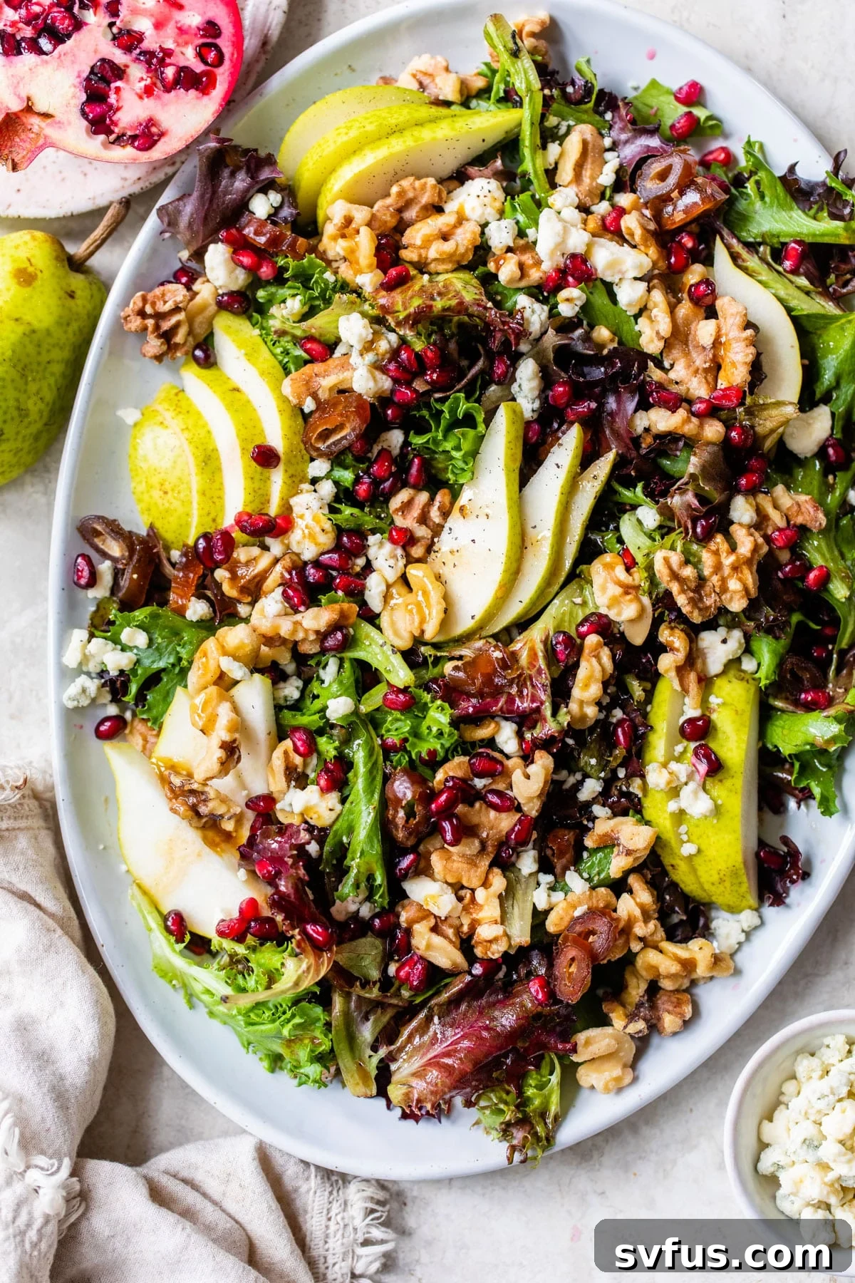 mixed greens salad with pear on a platter