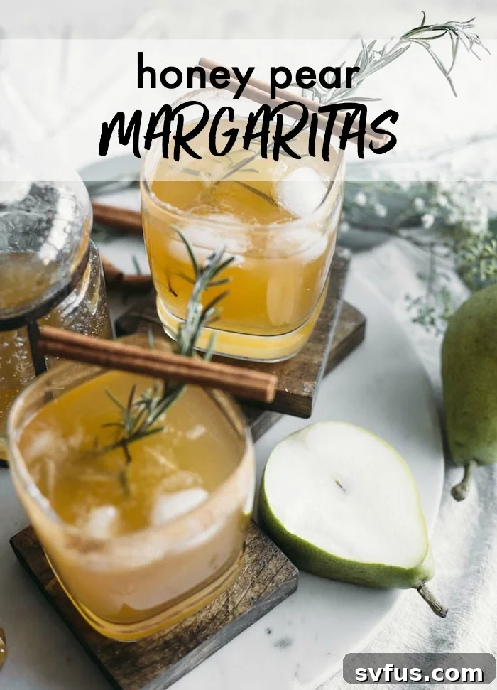 A pear margarita with a rosemary sprig and cinnamon sticks as a garnish