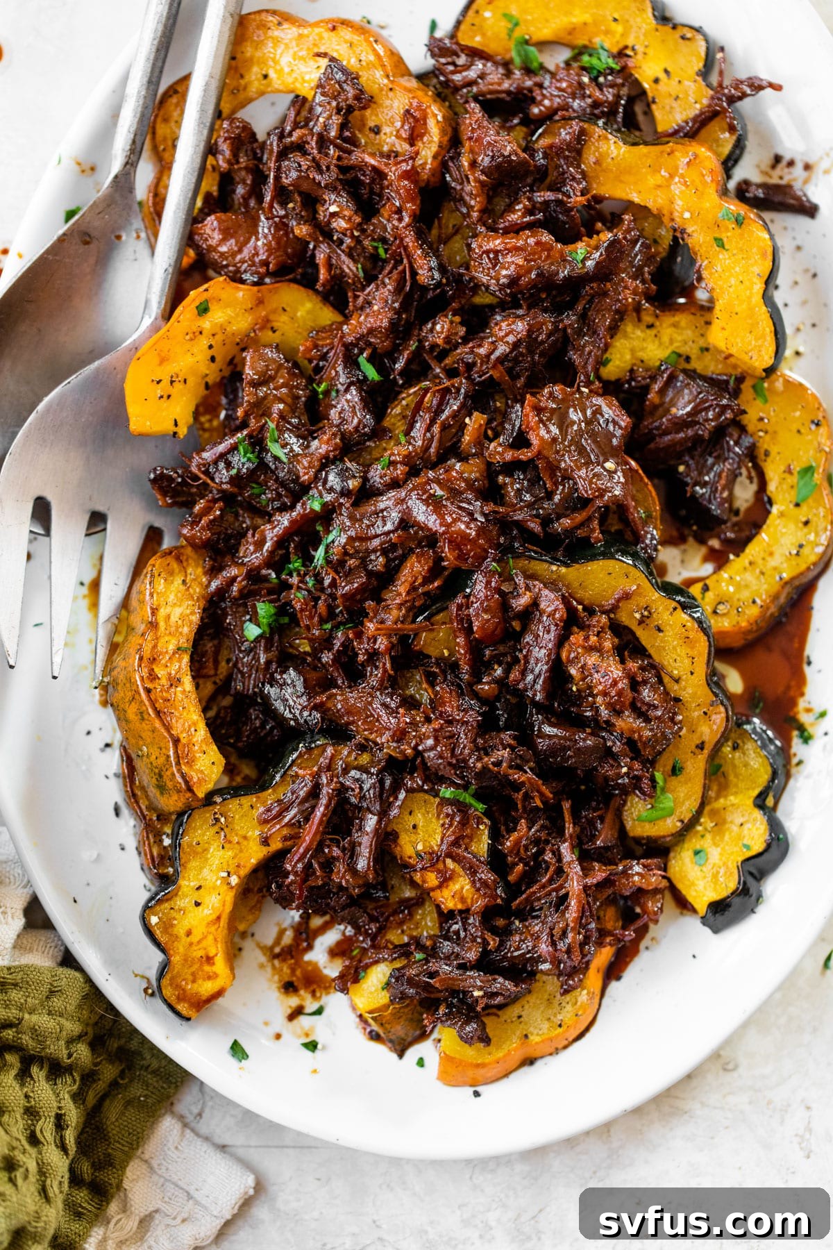 roasted acorn squash on a platter topped with pulled pork