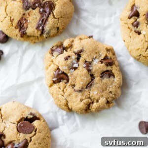 several cookies with chocolate chips on parchment paper