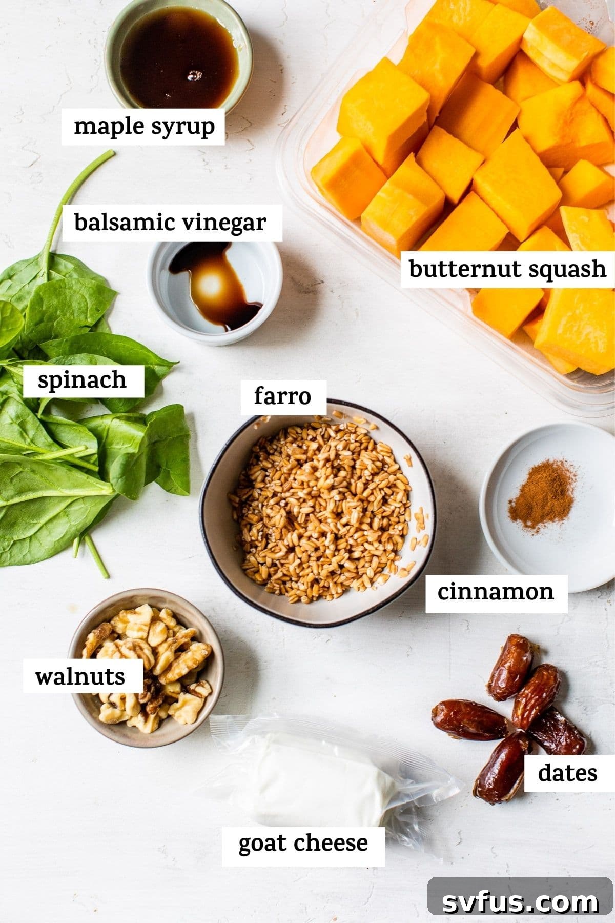 Individual bowls showing the prepared ingredients for Butternut Squash Farro Salad: cooked farro, chopped butternut squash, fresh spinach, walnuts, dates, and crumbled goat cheese.