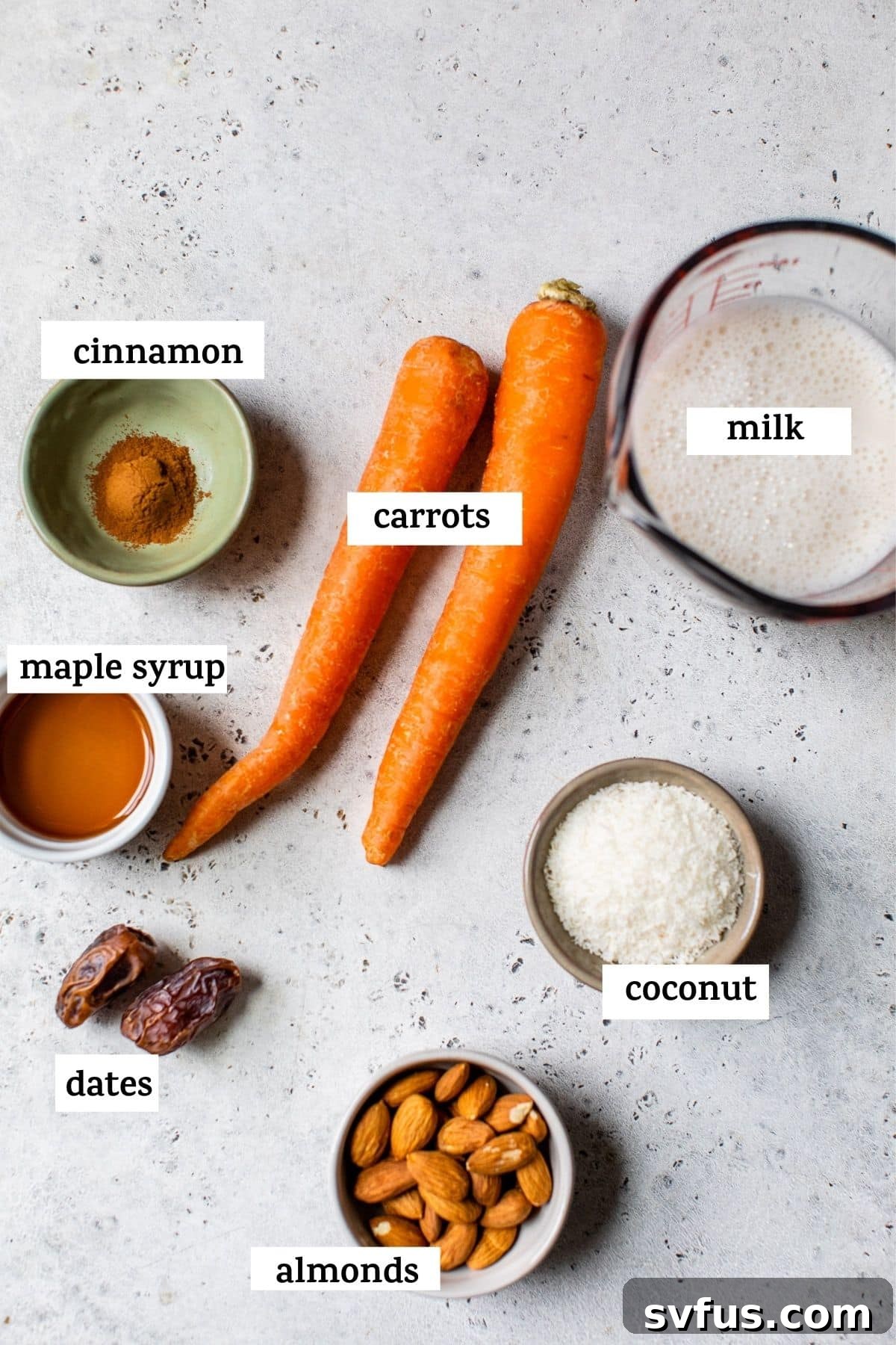 Various carrot cake smoothie ingredients displayed on a wooden table, ready for blending