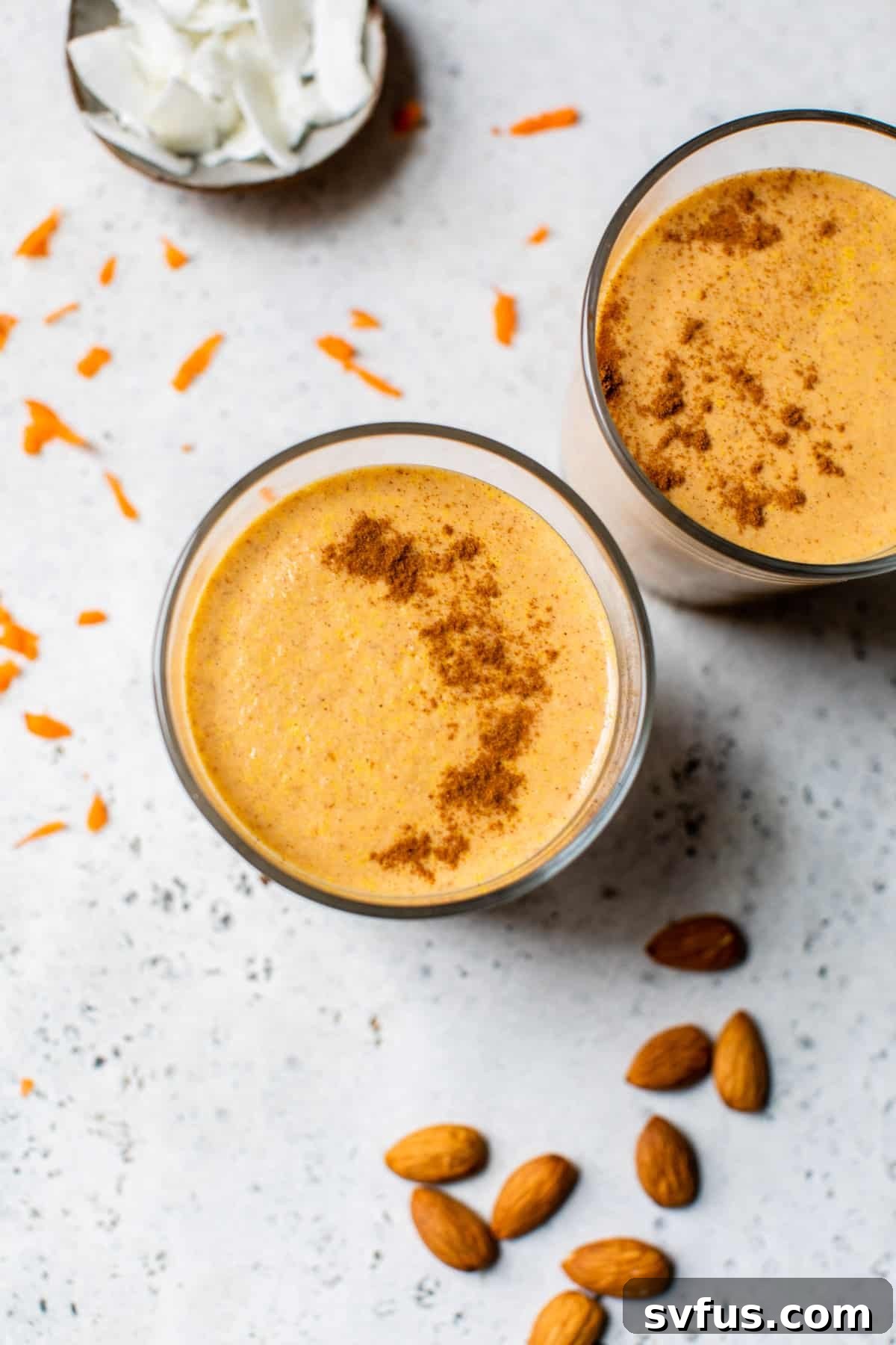 Overhead shot of a carrot cake smoothie in a glass, ready to be enjoyed