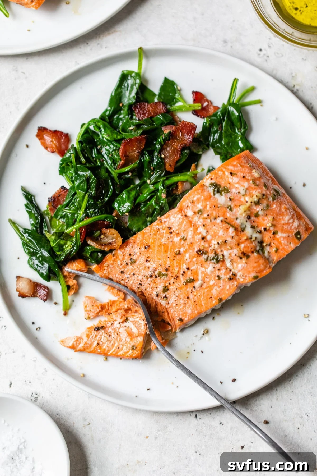 cooked salmon and spinach on a plate