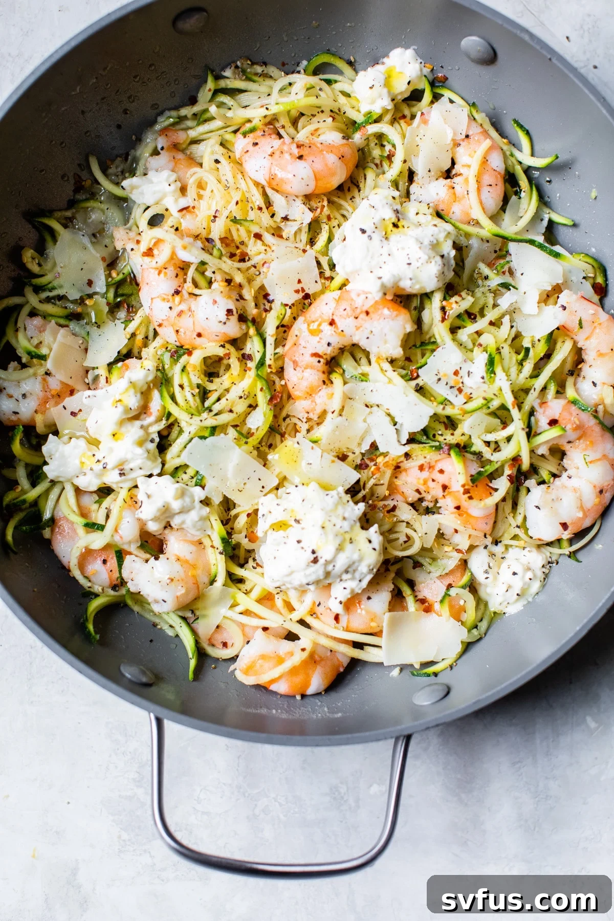 A bowl of food on a plate, with Pasta and Garlic