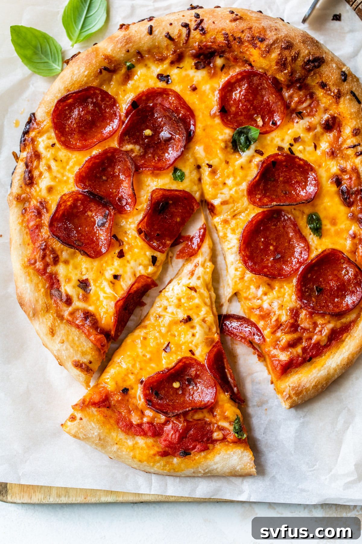 skillet pepperoni pizza with a slice cut out, showcasing the bubbly cheese and crispy crust