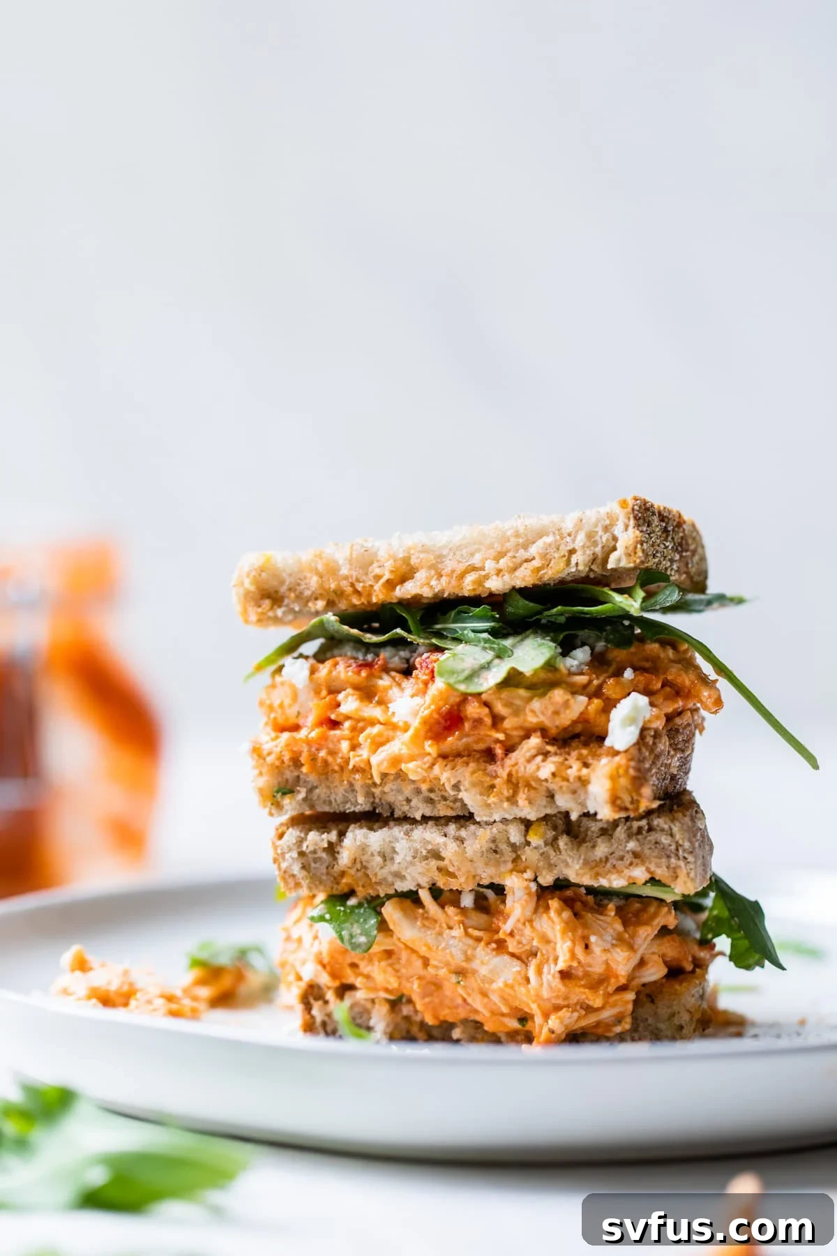 Stacked chicken salad sandwich featuring sun-dried tomato chicken salad