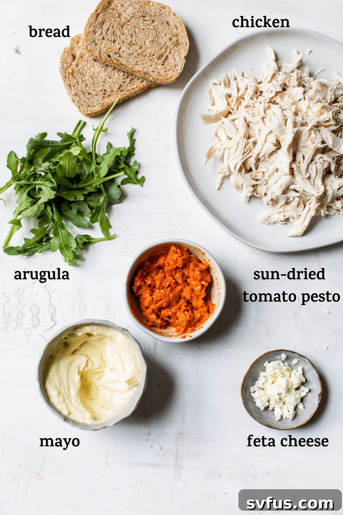 Sun-dried tomato chicken salad ingredients laid out on a counter