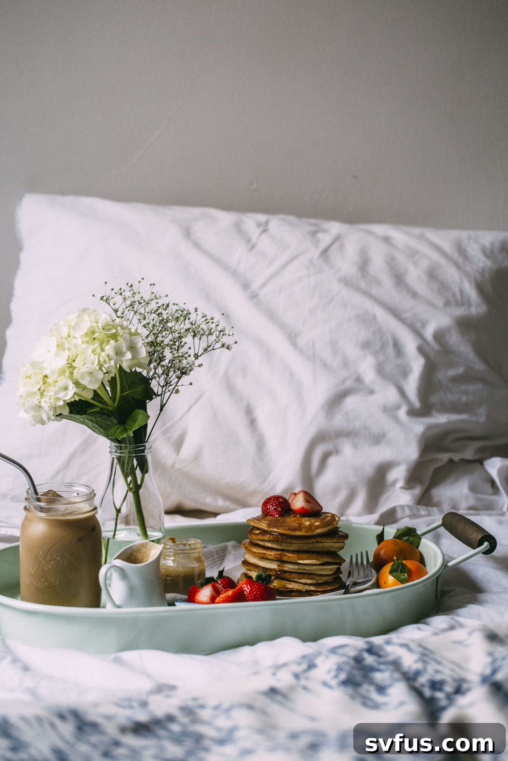 Close-up of golden brown Cinnamon Tahini Pancakes with a generous pour of maple tahini syrup