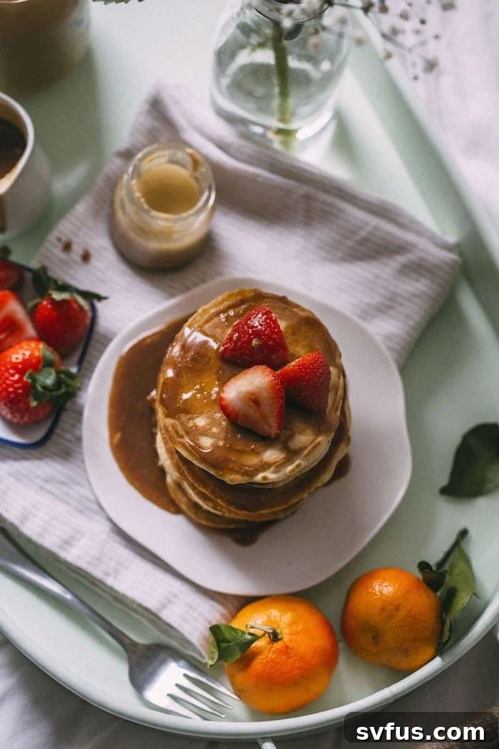 A close-up of a stack of healthy Tahini Pancakes with a rich syrup