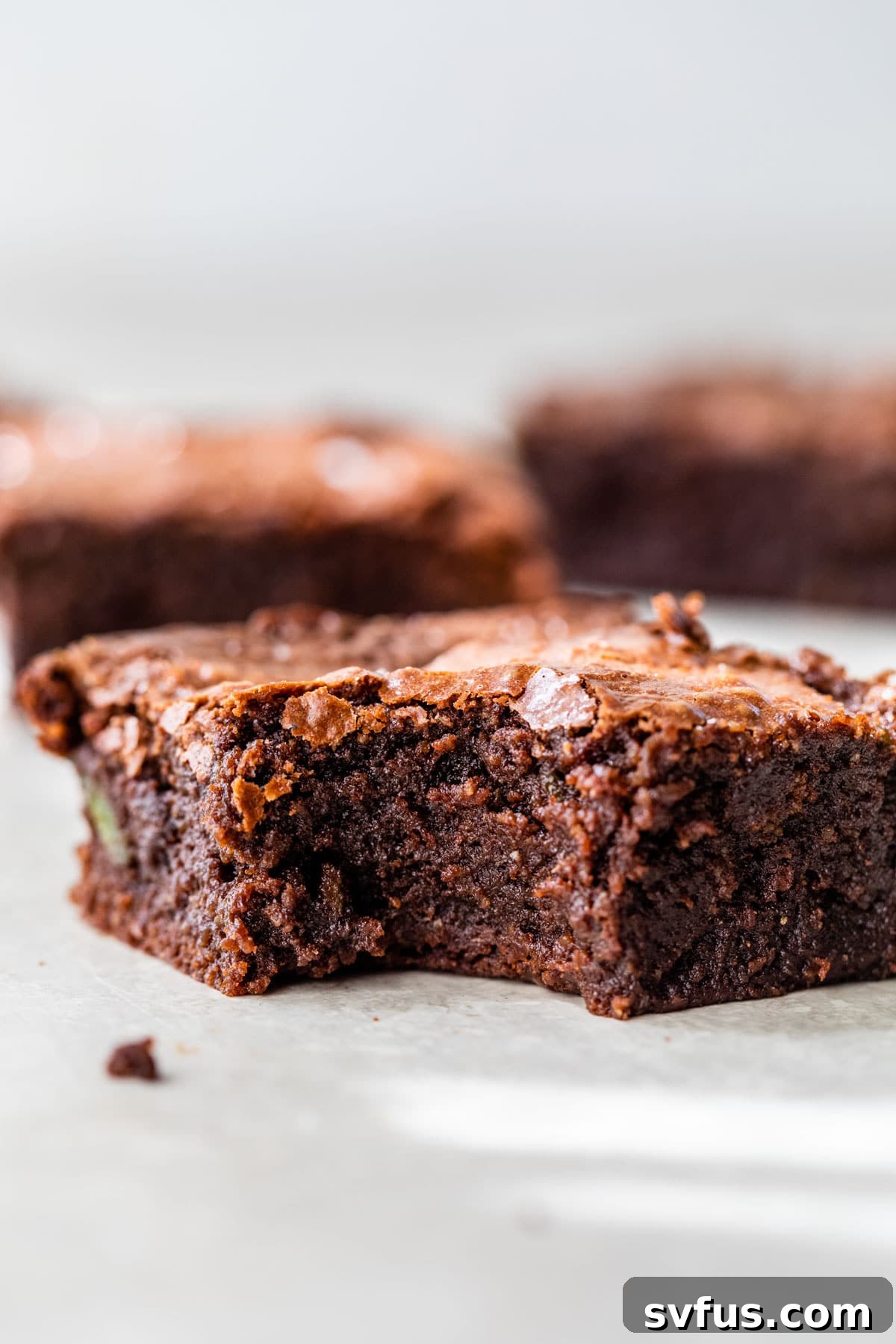 A delicious avocado brownie with a bite taken out, revealing its rich, fudgy interior.