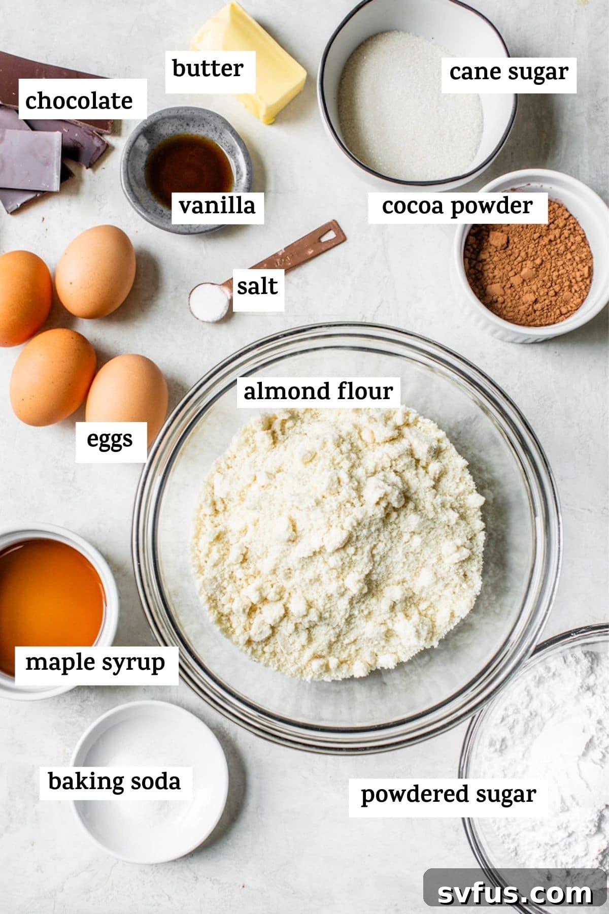 A collection of ingredients for chocolate cake laid out on a surface.